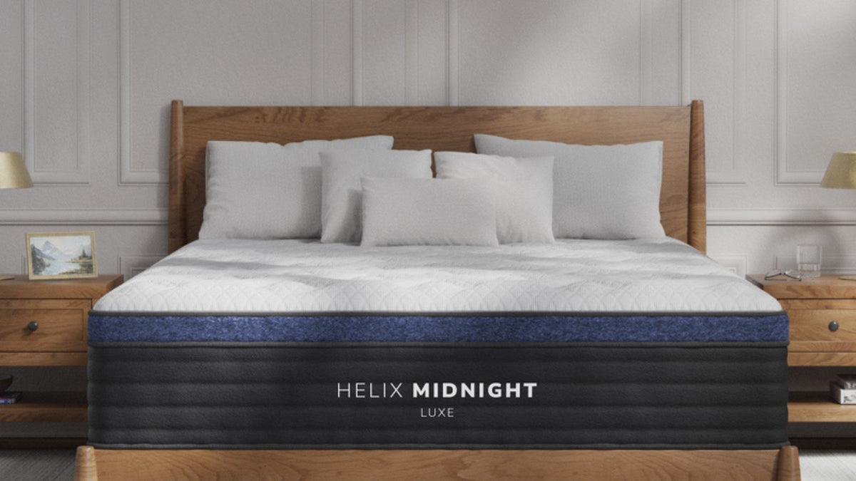 Helix Midnight Luxe hybrid mattress with a quilted pillow top on a wood platform bed in a bright bedroom