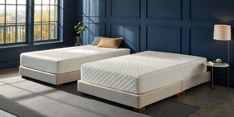 Two beds in a modern bedroom comparing a hybrid vs memory foam mattress.