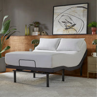 Bed with adjustable base in a bedroom setting with decor elements.