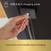 Hand plugging a USB cable into a car's USB A & C charging port.
